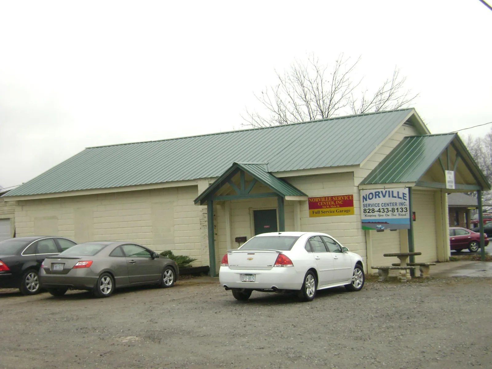 Green metal roof on a service garage with a covered entry in Arnaudville